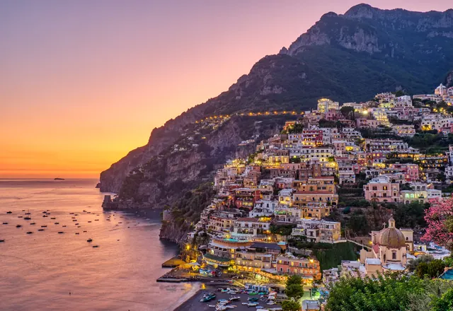 The houses of Positano lit up after sunset on the Amalfi Coast