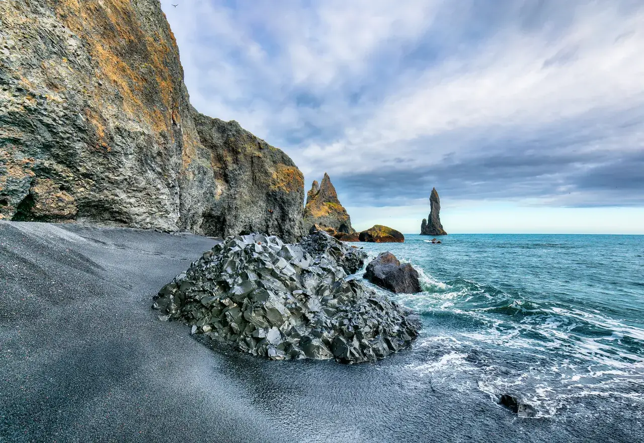 Basalt rocks and sea stacks on a black sand beach near Vík, Iceland